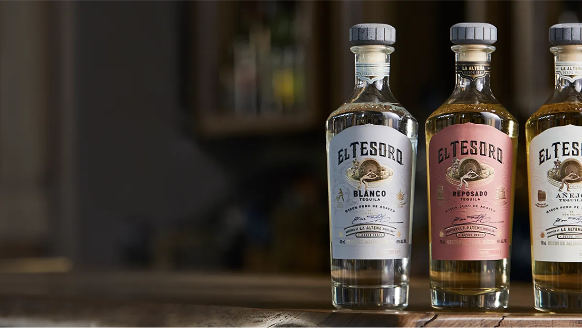 image of El Tesoro Tequila three bottles placed beside a wall